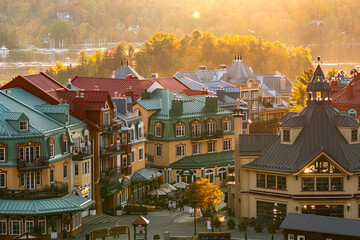 Mont-Tremblant, Quebec, Canada - October 03, 2023: House roofs surrounded by autumnal maple trees