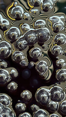A close-up of reflective metallic spheres surrounded by intricate ripple patterns, creating a mesmerizing abstract texture. Ideal for creative designs, tech visuals, or modern art concepts.