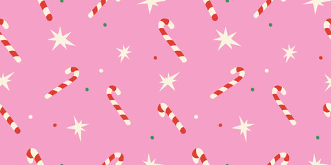 Cute Christmas seamless pattern with candy cane, stars on pink background for holiday designs.