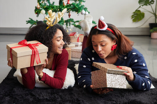 Friends opening Christmas presents