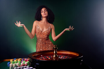Photo of stunning lucky girl dealer in casino rotating turning wheel and winning million money...