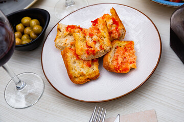 Pa amb tomaquet, traditional Spanish snack, toasted bread with tomato rubbed over and seasoned with olive oil and salt