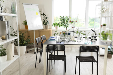 Interior of Biology classroom with table, flasks and plants