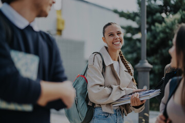 A group of cheerful students enjoying outdoor studying in a park. They exhibit friendship and learning with textbooks in hand, creating a vibrant and engaging atmosphere.