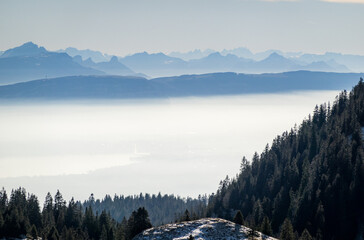 The French Alps rise above the mist on Lake Geneva