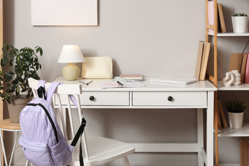 Student's workplace with notebooks and laptop in room