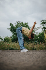 Girl enjoying time alone in the park, stretching and having fun outdoors. Perfect moment of relaxation and connection with nature.