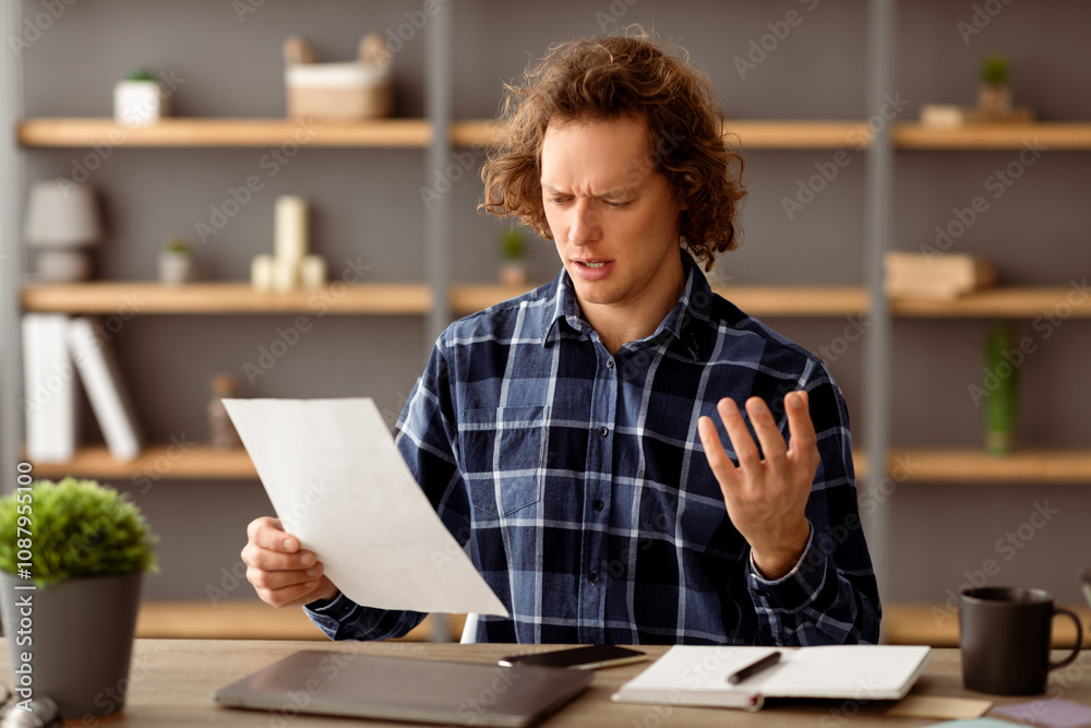 Poster discontented businessman reading negative business report having problem with financial bills sittin