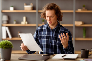 Discontented Businessman Reading Negative Business Report Having Problem With Financial Bills...