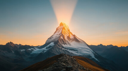Fototapeta premium Joyful , euphoria, radiance. A stunning mountain peak is illuminated by a radiant sunrise, casting golden light over the snow-capped summit and surrounding peaks, creating a breathtaking landscape.