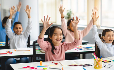 Elementary School and People Concept. Diverse excited group of emotional happy junior school kids...