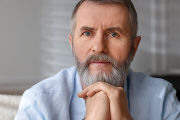 Portrait of handsome senior man at home