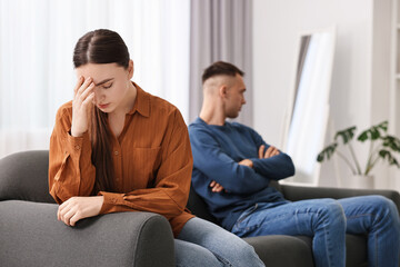 Obraz premium Offended couple ignoring each other at home, selective focus