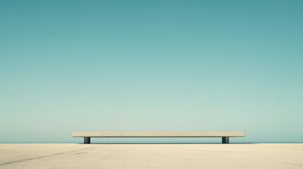 Minimalist concrete bench against a clear blue sky.