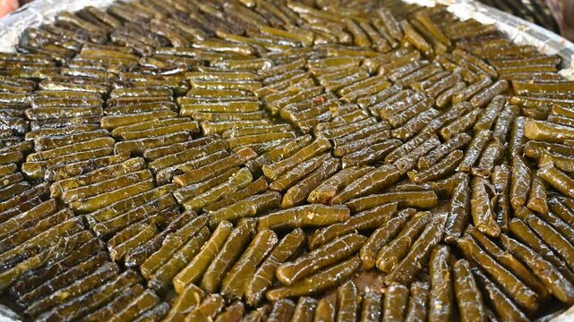 Sarma for sale in market. Traditional food in Turkey. Grapevine leaves rolled around a filling of minced meat and rice. 