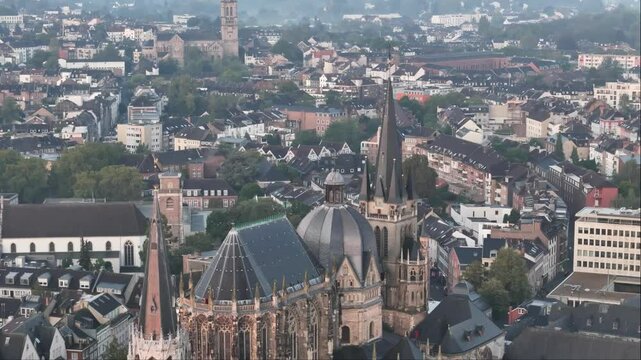 Drone view of the Aachener Dom and surrounding city in golden hour sunlight in Germany