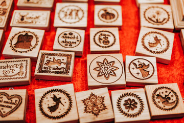 Christmas goods at the fair. cookie cutters on a red background.Symbol of winter holidays.Wooden molds with Christmas symbols and signs