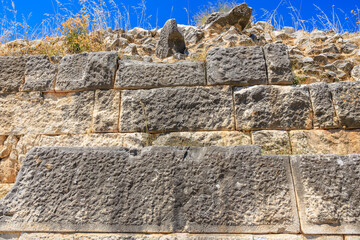 The wall is made of stone and has a rough texture. Ruins of the ancient city of Philippi, Greece