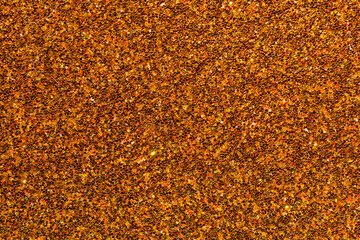 A close up of a brown and orange surface with a lot of small specks