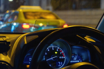 View of night traffic in the city through the windshield of a moving car