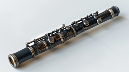 Naklejka premium Black wooden flute with silver keys on white background.