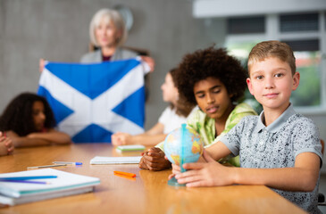 Fototapeta premium in geography lesson, elderly teacher very eloquently tells children about history of ancient scotland