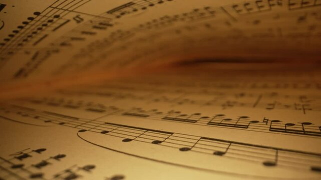 Slider macro background of saved medieval book with ancient musical notes writings. Texture of old handwritten classical symphony, beautiful melody, hobby concept. 
