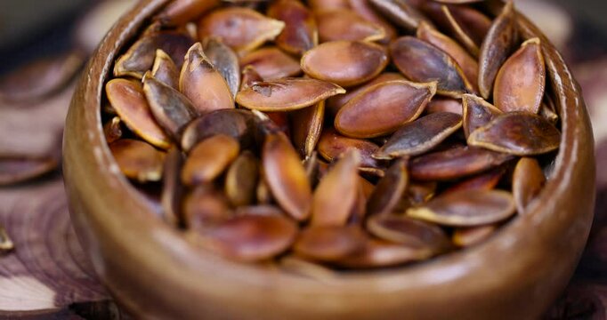 heavily fried pumpkin seeds in close-up, overcooked or burnt pumpkin seeds on the table