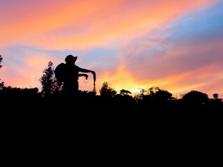 “Asian Woman Night Hiking with Lantern in Tropical Forest Adventure sunset