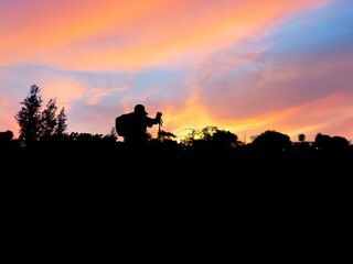 Fototapeta premium “Asian Woman Night Hiking with Lantern in Tropical Forest Adventure sunset