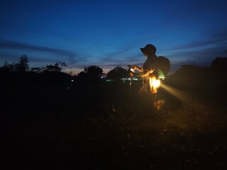 “Asian Woman Night Hiking with Lantern in Tropical Forest Adventure sunset