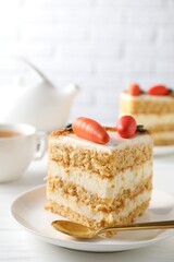 Piece of delicious carrot cake on white wooden table, closeup