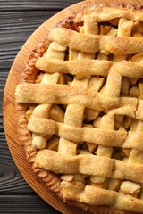 Tasty homemade apple pie on wooden table, top view
