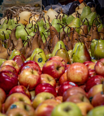 Apples and pears displayed at a farmers' market.