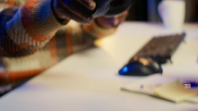 Videographer expert adjusting movie clips on computer at his home, working with color wheel to add visual effects. African american editor making fx montage for video post production. Camera A.