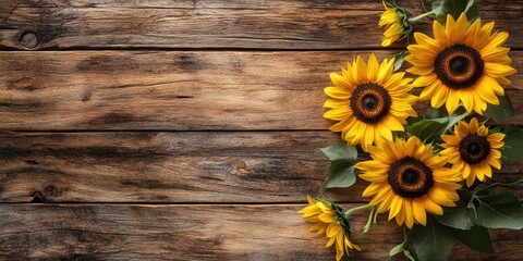 Obraz premium Sunflowers on a wooden surface, copy space.