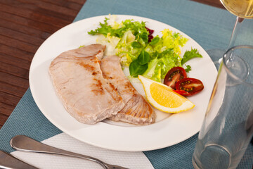 Tuna fillet platter with vegetable salad closeup