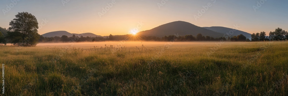 Aufkleber the sun rises gently over misty fields, illuminating rolling hills and creating a tranquil morning a