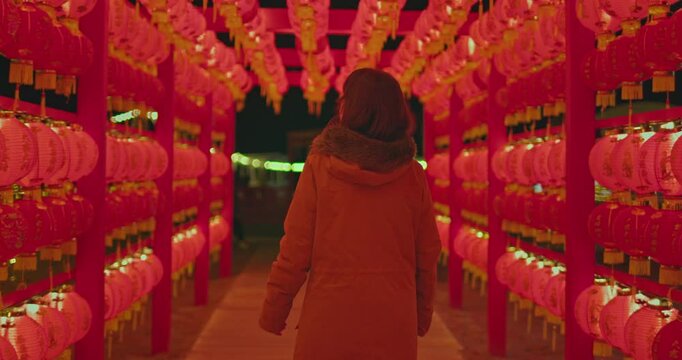 Female walk under Chinese red lanterns in the night on Chinese new year celebration