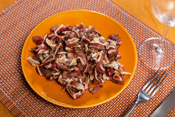 Sliced raw pork ears in seasonings served on plate