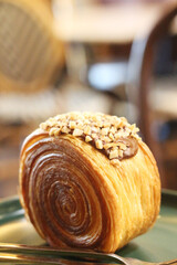 timbering nutella croissant with nuts on plate.
