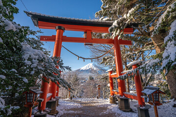 Red Japanese Torii pole, Fuji mountain and snow nature landscape background in winter season at Chureito pagoda, Japan