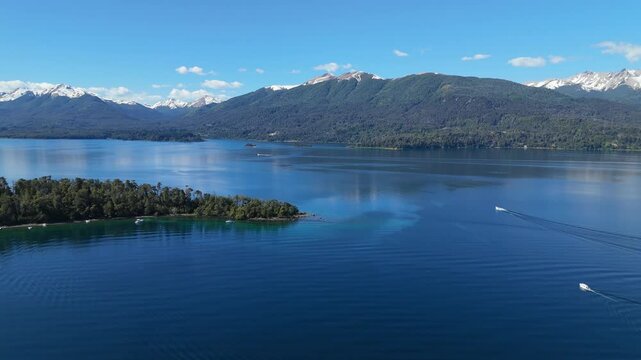 aerial view of Lynch Bay in the Arrayanes Forest, located within Nahuel Huapi Lake in Patagonia, Argentina. The pristine blue waters contrast with the lush green forest.