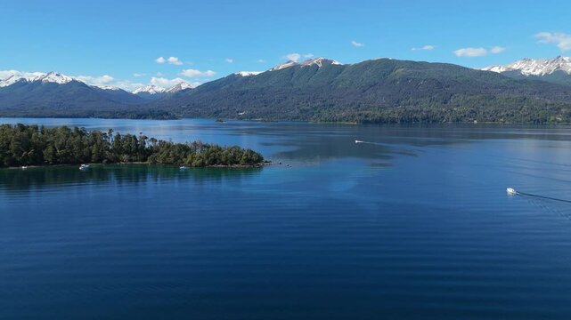 aerial view of Lynch Bay in the Arrayanes Forest, located within Nahuel Huapi Lake in Patagonia, Argentina. The pristine blue waters contrast with the lush green forest.