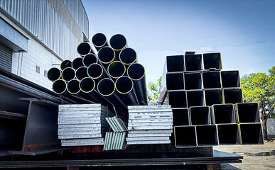 Stacked steel pipes with Construction steel, black pipe,Metal tubes, Angle steel, flat pipe, square...