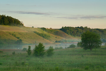 Fototapeta premium View of the Izborsko-Malskaya Valley and Gorodishchenskoe Lake on a sunny summer day, Izborsk, Pechersk district, Pskov region, Russia