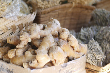 You can find Fresh Ginger Root displayed at a bustling Market Stall, inviting you over