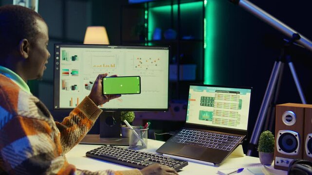 Expert analyst providing online evaluations of finances next to chroma key, solving accounting tasks for authorized balance analysis. Economist consultant estimates global earnings. Camera B.