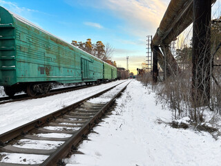Obraz premium Freight cars going into the distance through the forest on the railway