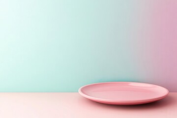 A minimalist pink plate rests on a soft pastel surface, with a gradient background blending soothing mint and pink hues.